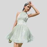 Sleeveless organza halter mini dress with tie-back detail and softly flared skirt
